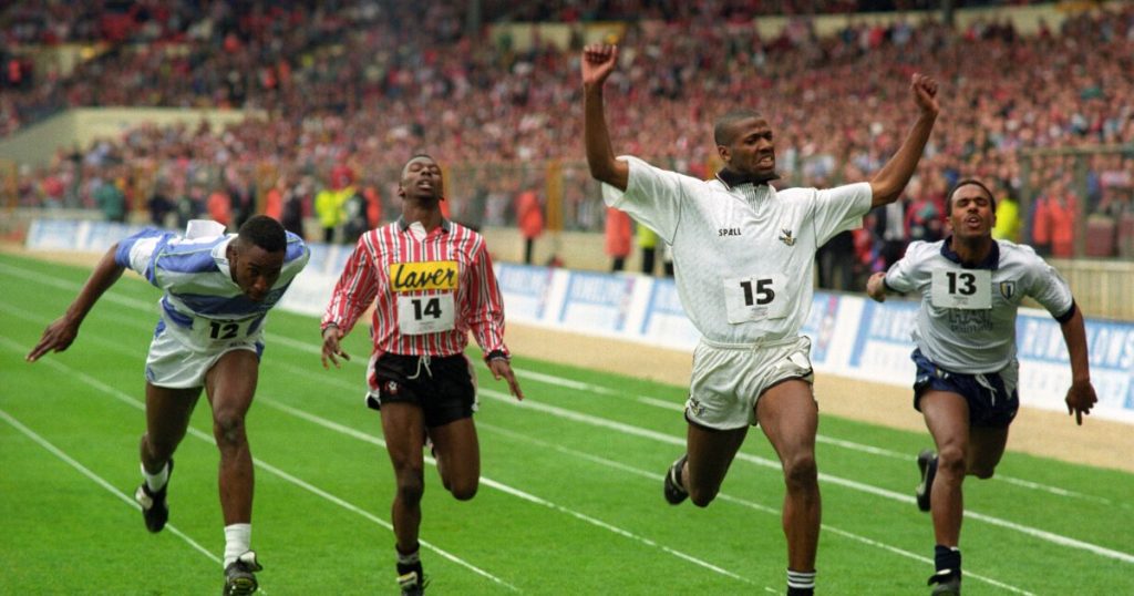 Swansea's John Williams wins a 100m race between footballers. Wembley