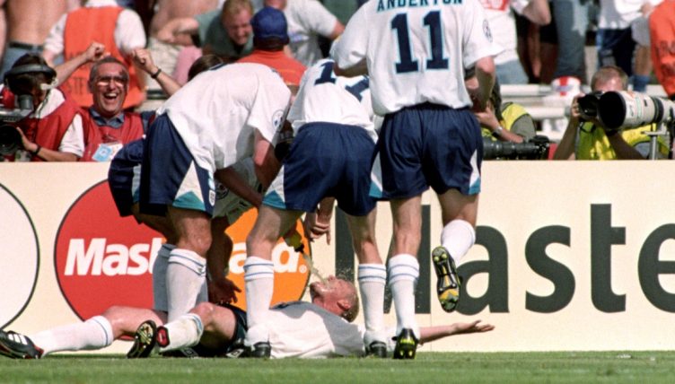 Paul Gascoigne is swamped by England teammates after scoring their second goal in the Euro 96 clash against Scotland, at Wembley. 15 June 1996.