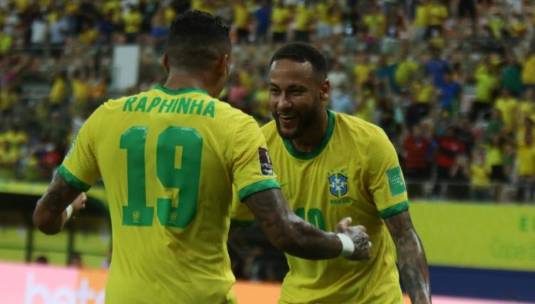 Raphinha celebrates with Neymar during Brazil's win against Uruguay.