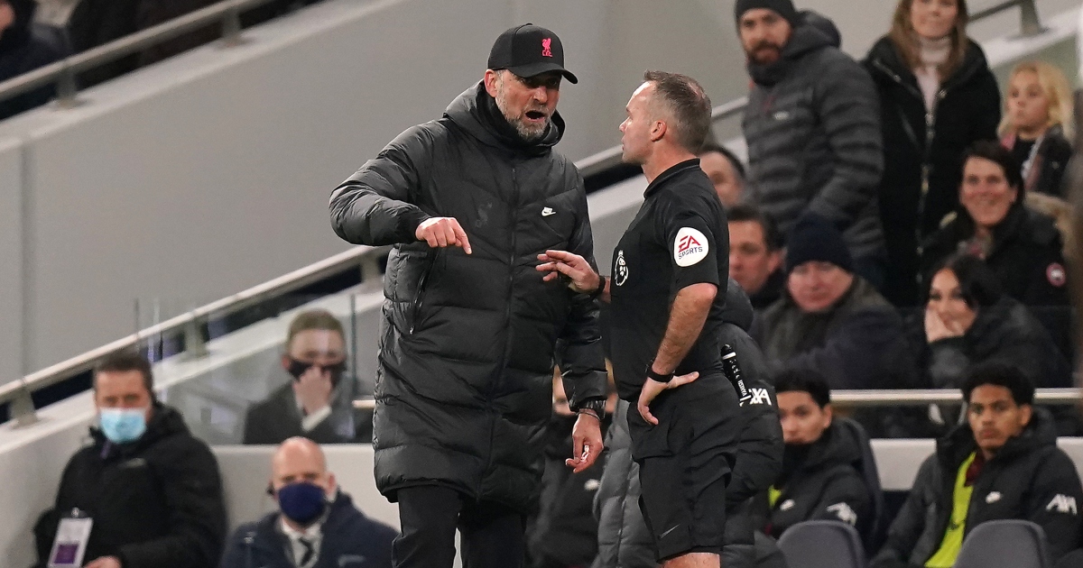 Referee Paul Tierney speaks with Liverpool manager Jurgen Klopp before showing him a yellow card.