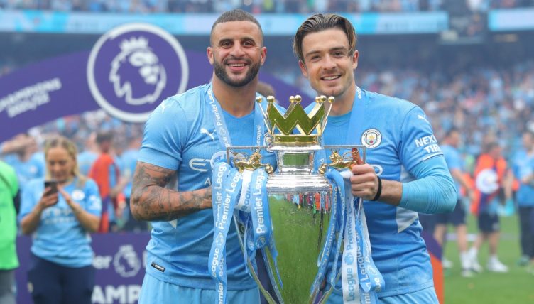 Manchester City's Kyle Walker and Jack Grealish with the Premier League trophy, Etihad Stadium, Manchester, May 2022.