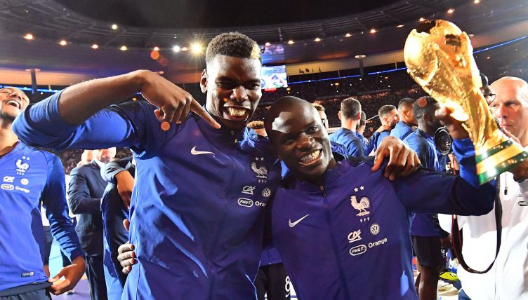 Paul Pogba, N'Golo Kante of France celebrate with the World Cup Trophy