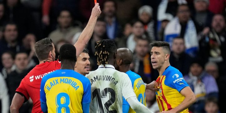 Valencia's Gabriel Paulista, right, is shown a red car by referee Javier Alberola Rojas during the Spanish La Liga soccer match between Real Madrid and Valencia at Santiago Bernabeu stadium in Madrid, Thursday, Feb. 2, 2023.