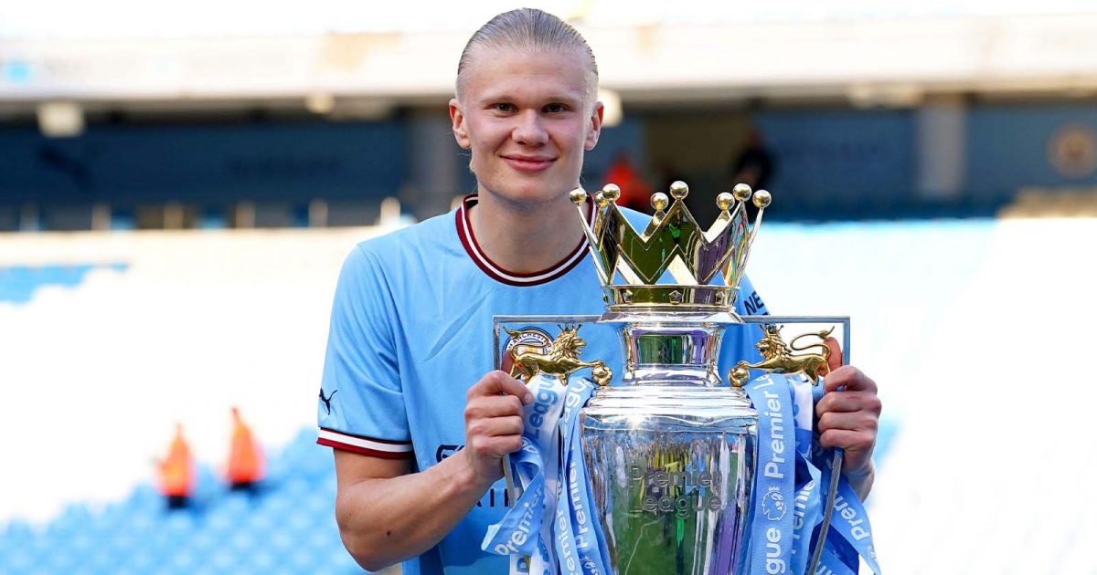 Manchester City's Erling Haaland celebrates with the Premier League trophy.