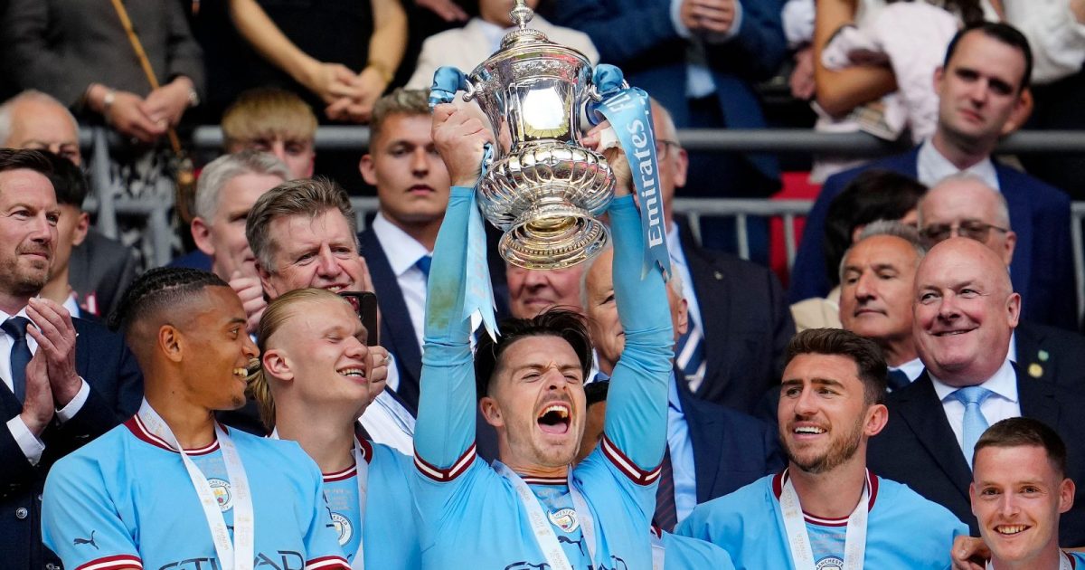 Manchester City's Jack Grealish raises the trophy after his team won the English FA Cup final soccer match between Manchester City and Manchester United at Wembley Stadium in London, Saturday, June 3, 2023.