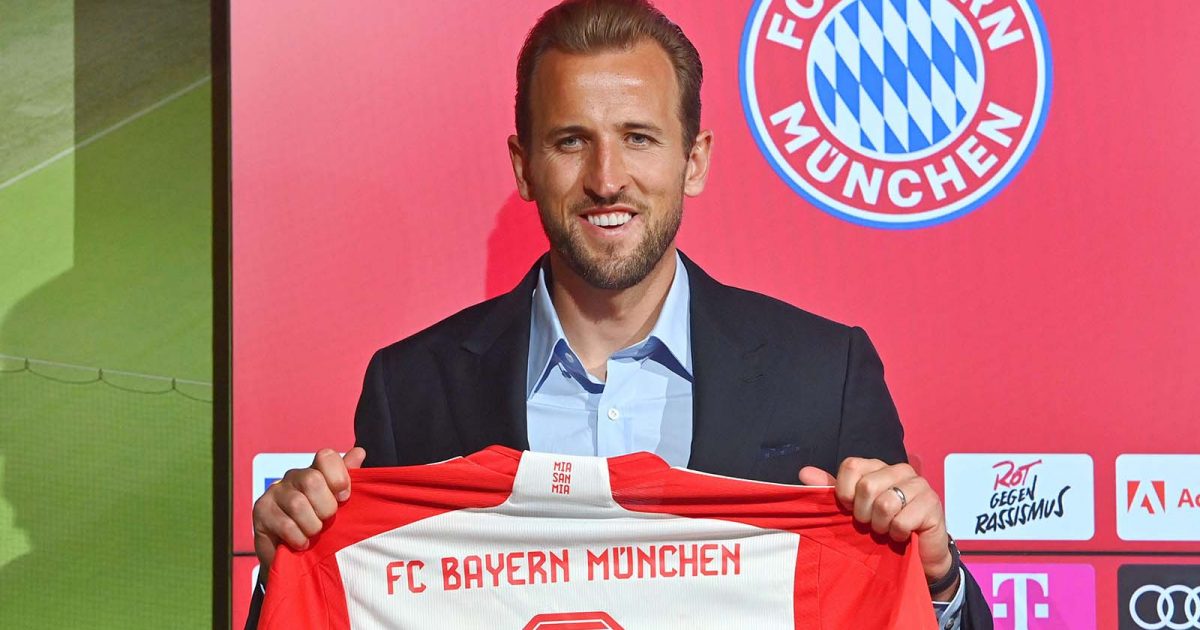 Bayern Munich's new player Harry Kane holds up a shirt at a press conference at the Allianz Arena