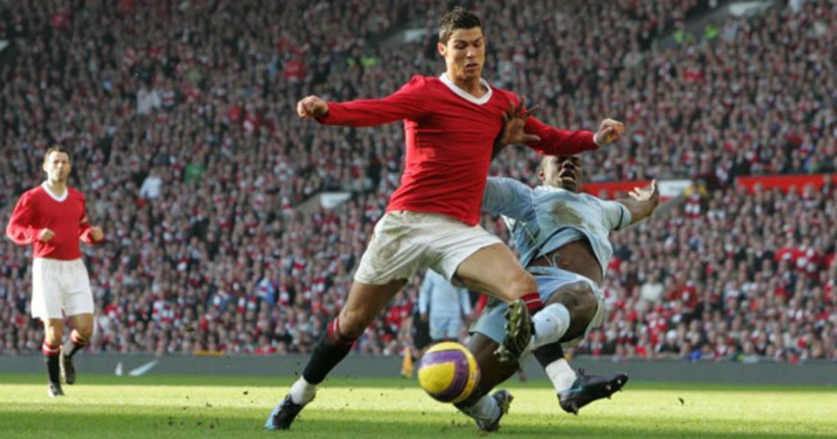 Cristiano Ronaldo is tackled by Micah Richards during the Premier League match between Manchester United and Manchester City at Old Trafford, Manchester, February 2008.
