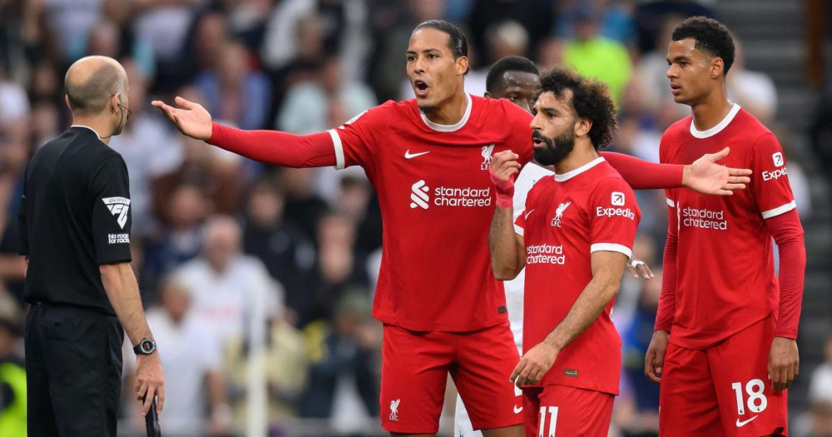 Liverpool players Virgil van Dijk, Mo Salah and Cody Gakpo and Tottenham's James Maddison await referee Simon Hooper's decision as he checks the VAR screen during the match against Tottenham.