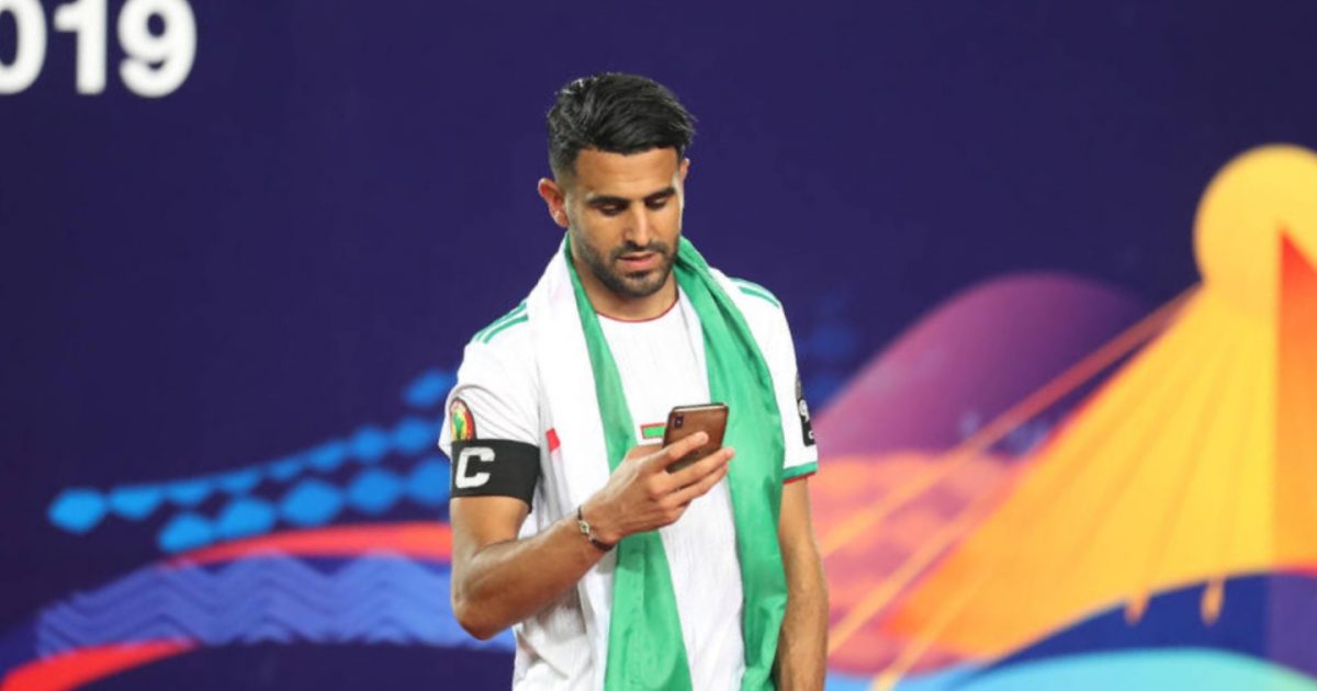 Cairo, Egypt. 19th July, 2019. Algeria's Riyad Mahrez uses his phone during the award ceremony after Algeria defeated Senegal in the 2019 Africa Cup of Nations final soccer match at the Cairo International Stadium.