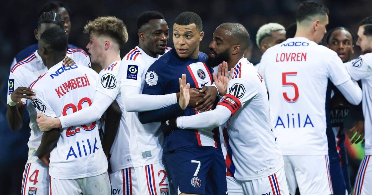 PSG's Kylian Mbappe, centre, argues with Lyon's players during the French League One soccer match between Paris Saint-Germain and Lyon at the Parc des Princes stadium in Paris, Sunday, April 2, 2023