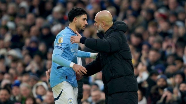 Manchester City's head coach Pep Guardiola embraces Manchester City's Omar Marmoush as he leaves the pitch after being replaced during the English Premier League soccer match between Manchester City and Newcastle United at Etihad stadium in Manchester, England, Saturday, Feb. 15, 2025.