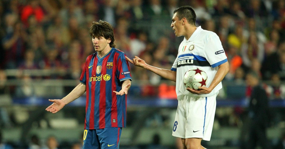Inter Milan's Ferreira Lucio confronts Barcelona's Lionel Messi