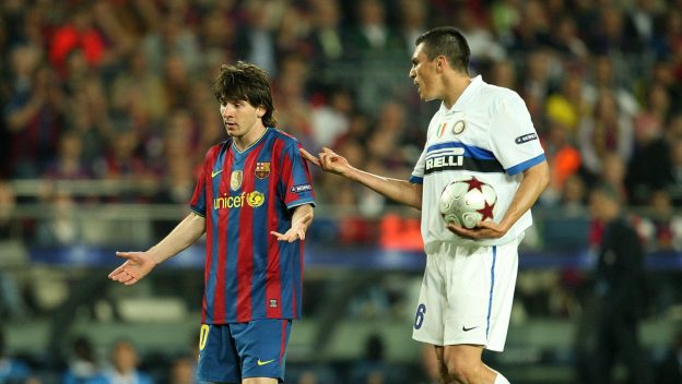 Inter Milan's Ferreira Lucio confronts Barcelona's Lionel Messi