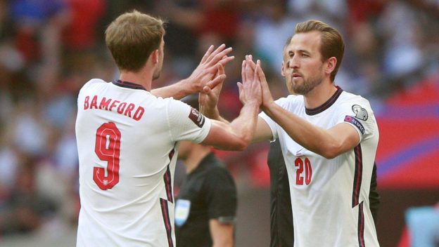 England's Harry Kane replaces teammate Patrick Bamford, left, during the World Cup 2022 group I qualifying soccer match between England and Andorra at Wembley stadium in London, Sunday, Sept. 5, 2021