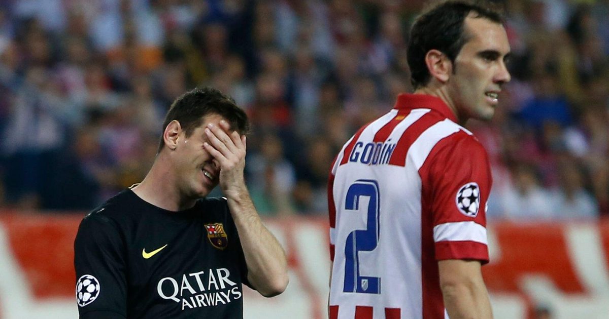 Barcelona's Lionel Messi and Cesc Fabregas react next to Atletico's Diego Godin, right, during the Champions League quarterfinal second leg soccer match between Atletico Madrid and FC Barcelona at the Vicente Calderon stadium in Madrid, Spain, Wednesday, April 9, 2014.