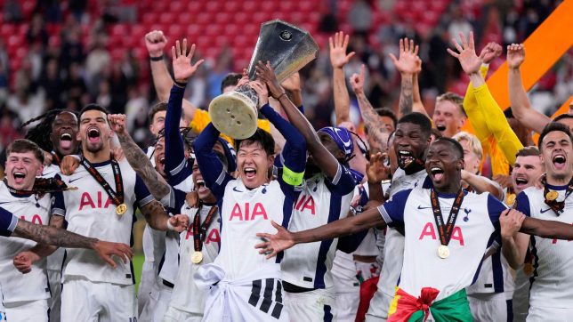 The 2025 winners celebrate with the trophy.