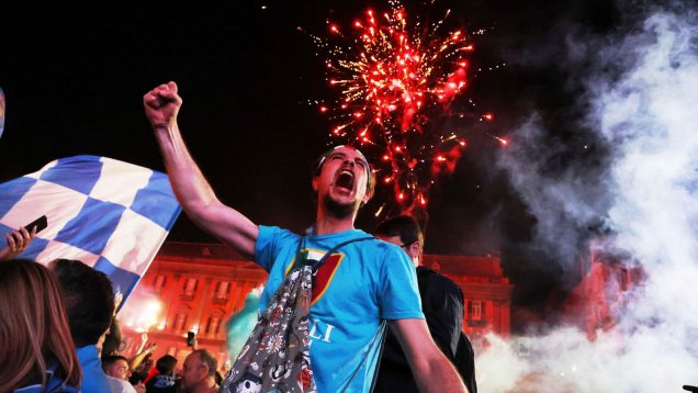 A supporter of the 2025 champions celebrates in the streets.