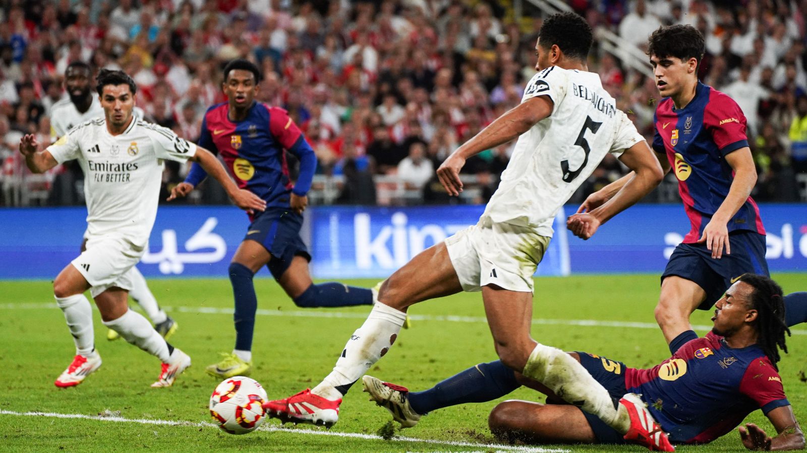 Jeddah, Saudi Arabia. 12th Jan, 2025. Real Madrid's English player Jude Bellingham (C) seen in action with Barcelona's French player Jules Kounde (R|) during the Spanish Super Cup final match El Clasico between FC Barcelona and Real Madrid at King Abdullah Sports City. Final Score : Real Madrid 2 : 5 FC Barcelona