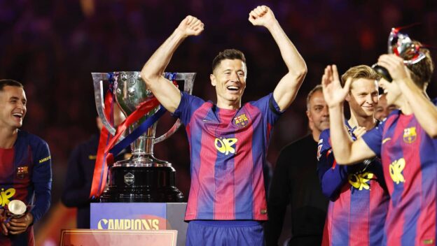 Robert Lewandowski and Barcelona teammates celebrating with the La Liga trophy.