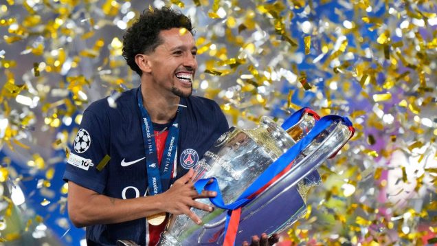 PSG's team captain Marquinhos holds the trophy after winning the Champions League final soccer match between Paris Saint-Germain and Inter Milan at the Allianz Arena in Munich, Germany, Saturday, May 31, 2025.