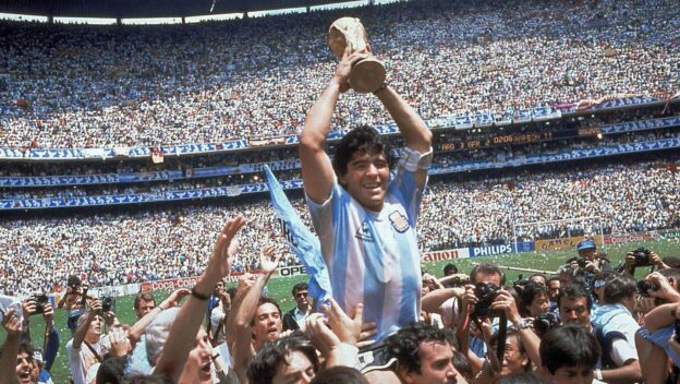 The winning captain of the 1986 tournament lifts the trophy.