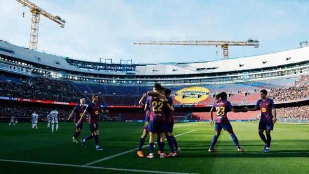 Barcelona players celebrate one of their three goals against Levante.