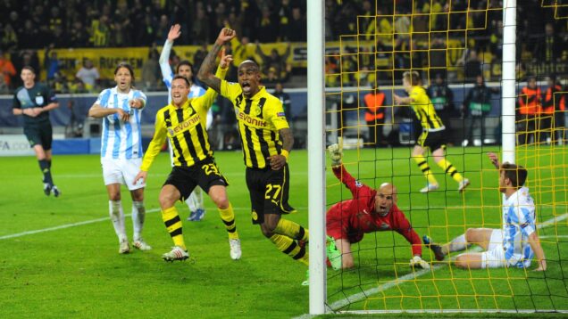 Dortmund players celebrate their very late and very controversial winner.