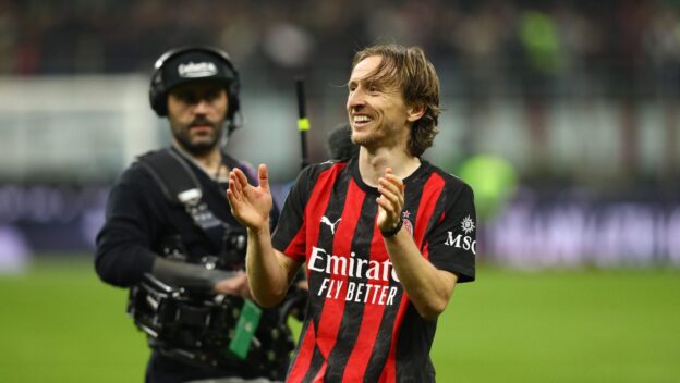 Luka Modric celebrates after Milan's victory over city rivals Inter.