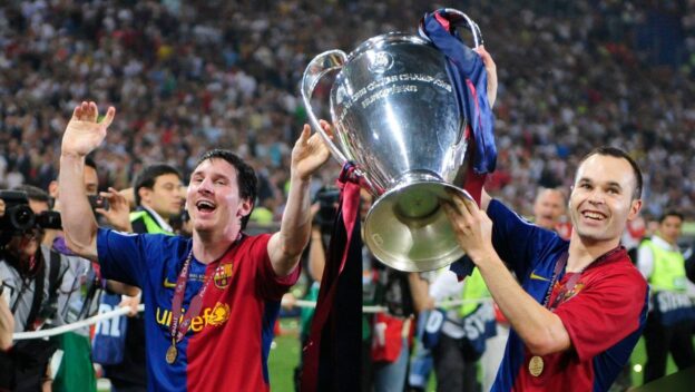 Barcelona's Andres Iniesta, right, and Lionel Messi hold the trophy at the end of the UEFA Champions League final soccer match between Manchester United and Barcelona in Rome, Wednesday May 27, 2009. Barcelona won 2-0.