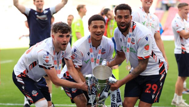 Bolton Wanderers' Maxwell Conway, Mason Burstow and Cyrus Christie celebrate with the trophy after clinching promotion following the Sky Bet League One play-off final at Wembley Stadium, London. Picture date: Sunday May 24, 2026.