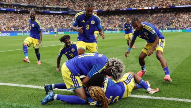 Curacao players celebrate scoring against Germany at the World Cup.