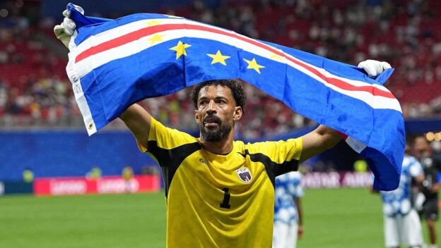 Vozinha with a Cape Verde flag at the 2026 World Cup